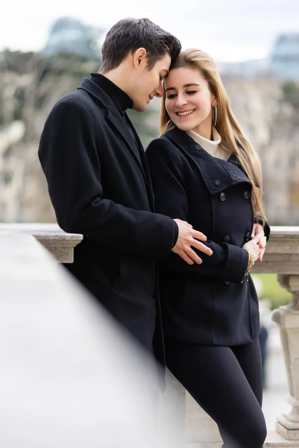 Engaged couple sharing an intimate moment in Vienna's Burggarten
